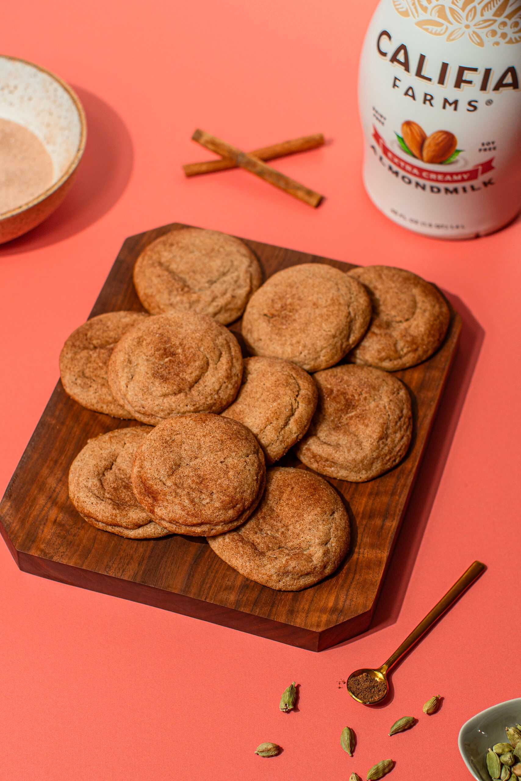 Chai cookies sit in the center of the image, with Califia Farms Extra Creamy Almondmilk behind.